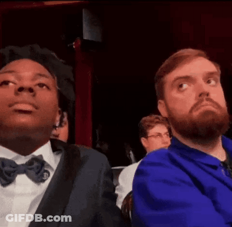 Man With Beard Sitting Next To Man In Blue Jacket GIF