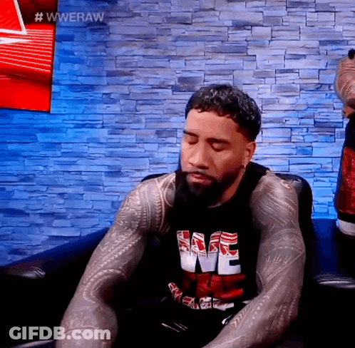 Man With Beard Sitting On Couch Eyes Closed Wearing We Shirt GIF