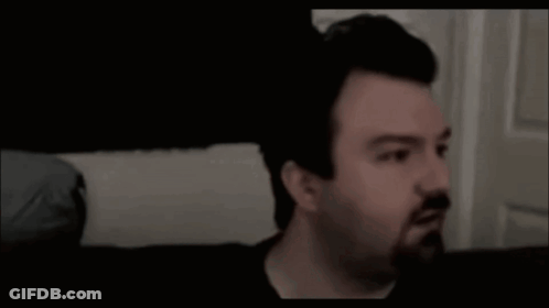 Man With Beard Sitting On Couch Saying Hellooo GIF
