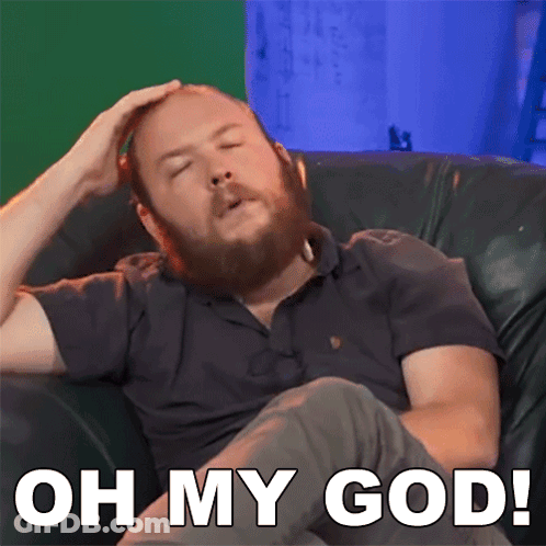 Man With Beard Sitting On Couch Saying Oh My God GIF