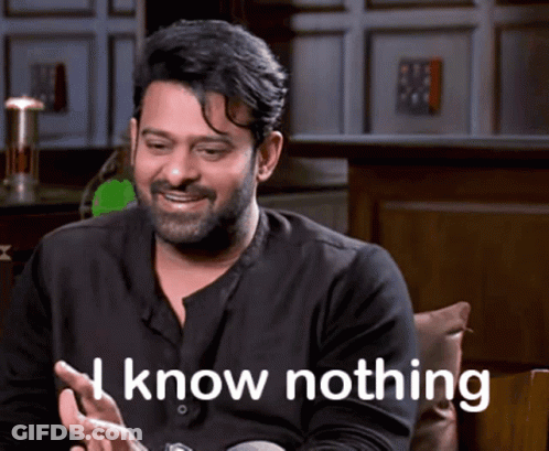 Man With Beard Sitting Smiling Saying I Know Nothing GIF