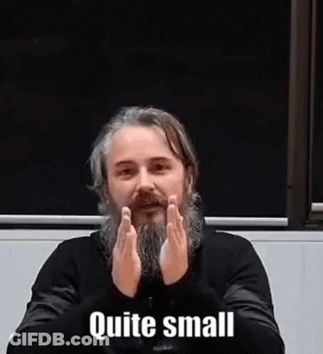 Man With Beard Sitting With Hands Folded Saying Quite Small GIF