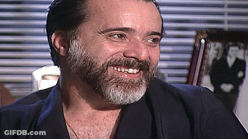 Man With Beard Smiling At Window GIF