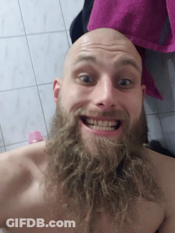 Man With Beard Smiling In Bathroom With Pink Towel GIF