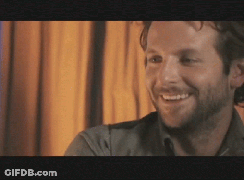 Man With Beard Smiling In Dark Room GIF