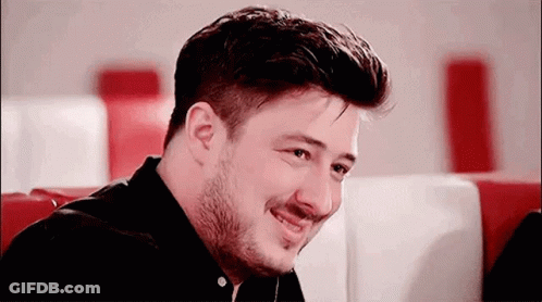 Man With Beard Smiling In Diner GIF