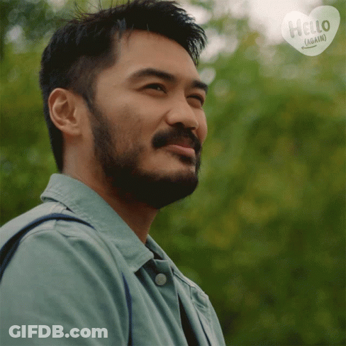 Man With Beard Smiling In Front Of Hello Again Sign GIF