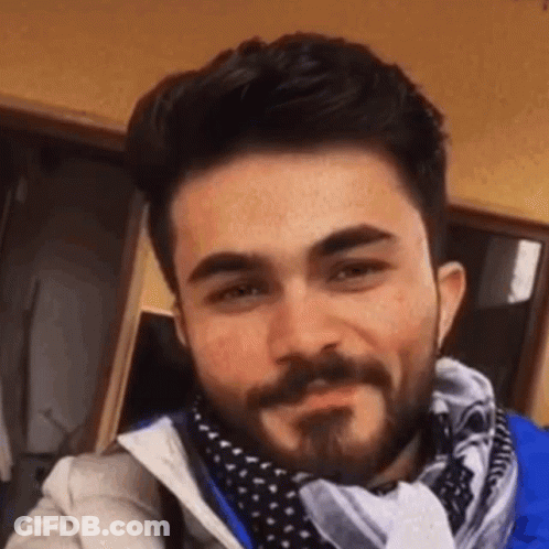 Man With Beard Smiling In Scarf And Jacket GIF