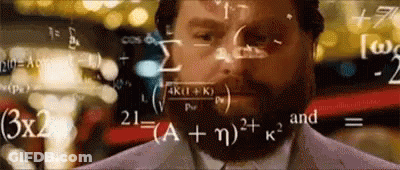 Man With Beard Standing In Front Of Chalkboard With Math Equations GIF
