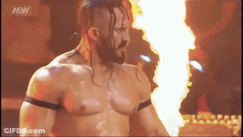 Man With Beard Standing In Front Of Fire And AEW Logo GIF