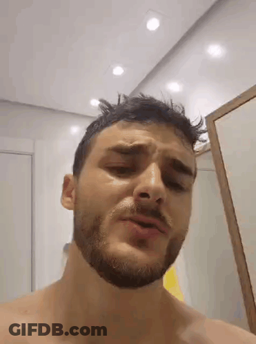 Man With Beard Standing In Front Of Mirror GIF