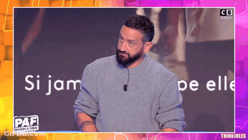 Man With Beard Standing In Front Of Paf Screen GIF