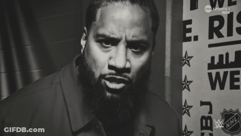 Man With Beard Standing In Front Of Sign Saying We GIF