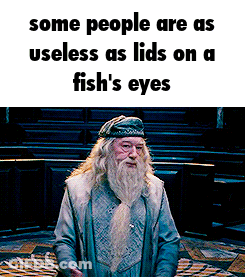 Man With Beard Standing In Front Of Sign Some People Are Useless GIF
