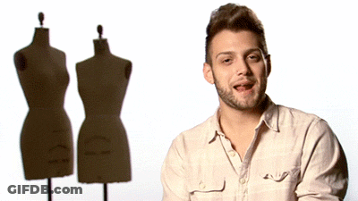 Man With Beard Standing In Front Of Three Mannequins GIF
