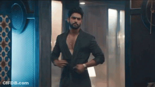 Man With Beard Standing In Room Shirt Off GIF