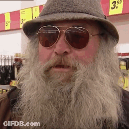 Man With Beard Sunglasses Hat In Front Of Sign Saying 3.59 GIF