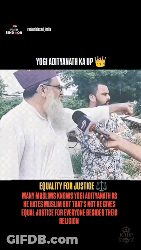 Man With Beard Talking Into Microphone While Another Man Looks On GIF