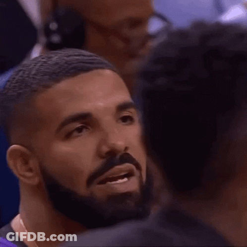 Man With Beard Talking To Another In Crowd GIF
