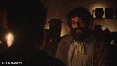 Man With Beard Talking To Another Man In Dark GIF