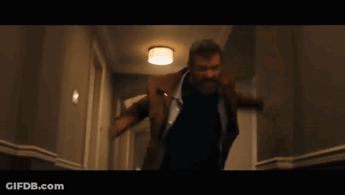 Man With Beard Walking Down Hallway GIF