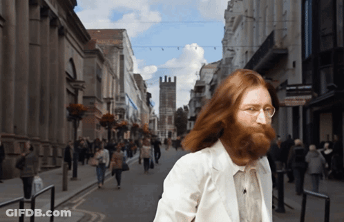 Man With Beard Walking Down Street GIF