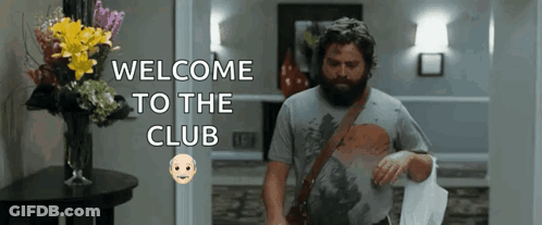 Man With Beard Walking Through Hallway GIF