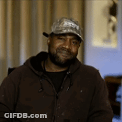 Man With Beard Wearing Baseball Cap And Brown Jacket GIF