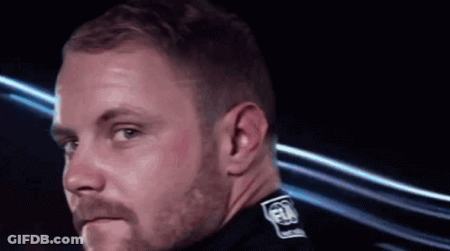 Man With Beard Wearing Black Shirt With FIA On Collar GIF