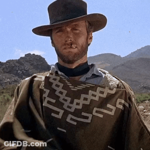 Man With Beard Wearing Geometric Poncho GIF