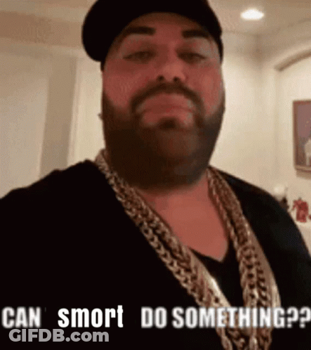 Man With Beard Wearing Hat And Gold Chain Says Can Smrt Do Something GIF