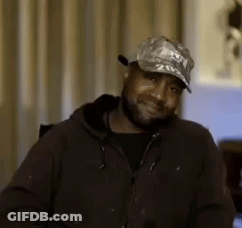 Man With Beard Wearing Hat And Jacket Smiling GIF