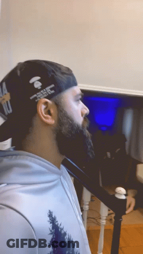 Man With Beard Wearing Hat That Says A Bathing Ape GIF