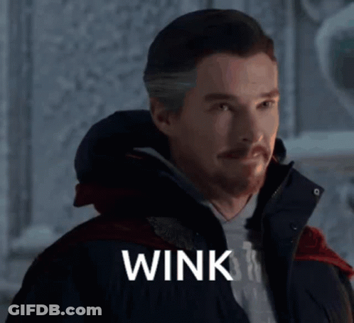 Man With Beard Wearing Jacket Saying Wink GIF