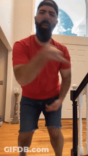 Man With Beard Wearing Red Shirt And Blue Shorts GIF
