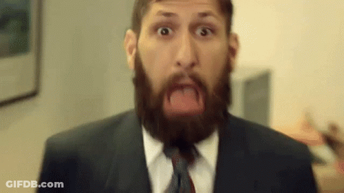 Man With Beard Wearing Suit And Tie Making Funny Face GIF