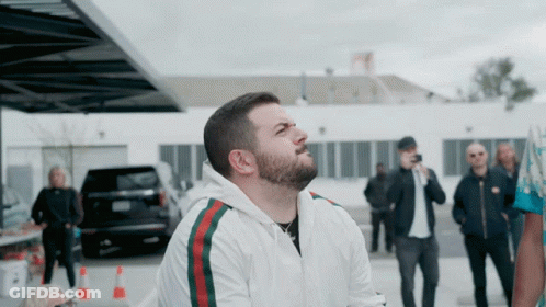Man With Beard Wearing White Jacket Green Red Stripe GIF