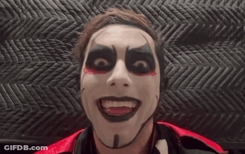 Man With Black And Red Makeup Looking At Camera GIF