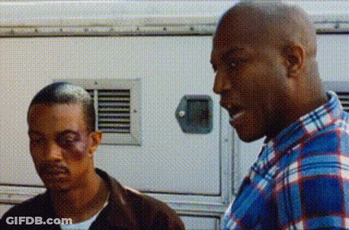 Man With Black Eye Beside Man In Plaid Shirt GIF