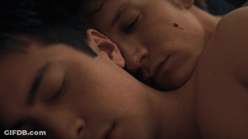 Man With Black Spot Laying On Another Man's Chest GIF
