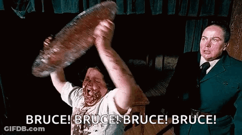 Man With Blood Holding Large Meat GIF