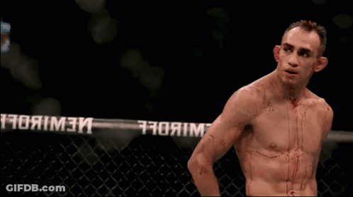 Man With Blood On Chest In Front Of UFC Fence GIF