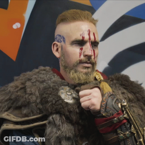Man With Blood On Face And Beard In Fur Coat Holding Sword GIF