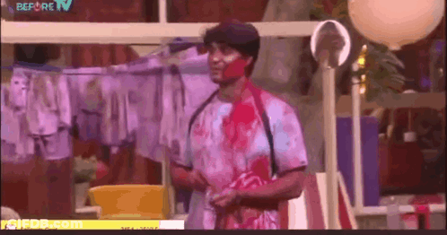 Man With Blood On Face In Front Of Clothesline GIF