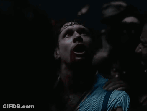 Man With Blood On Face Surrounded By Crowd GIF