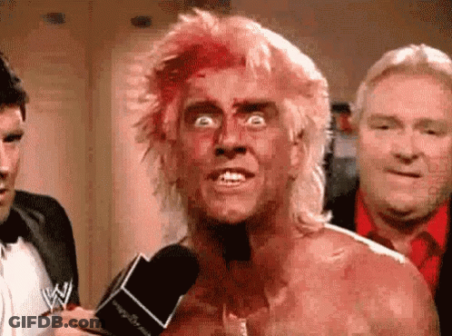 Man With Blood On Face Talking Into Microphone GIF