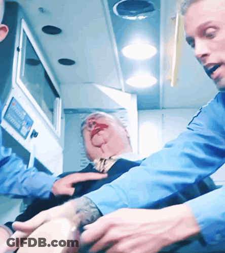 Man With Blood On Face Treated By Doctor GIF