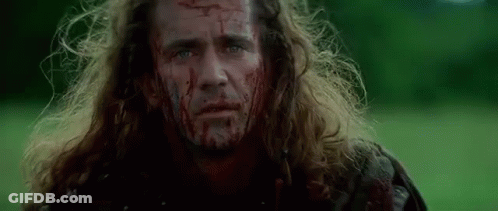 Man With Blood On His Face Standing In Field GIF