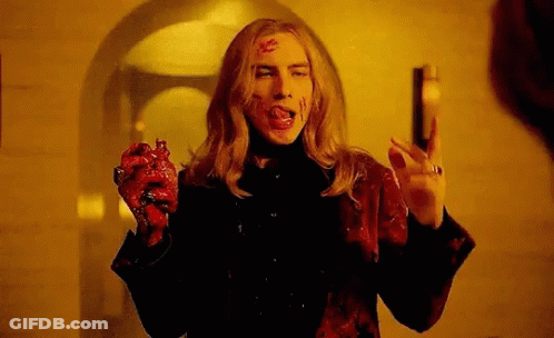 Man With Bloody Face Holding Heart And Gun GIF