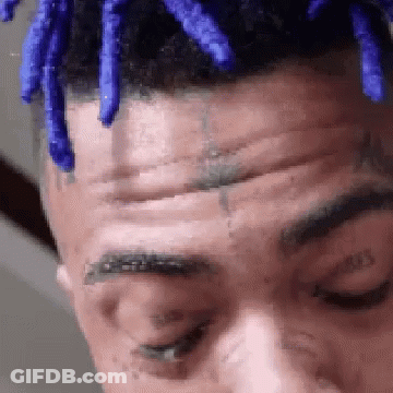 Man With Blue Dreadlocks And Forehead Tattoo GIF